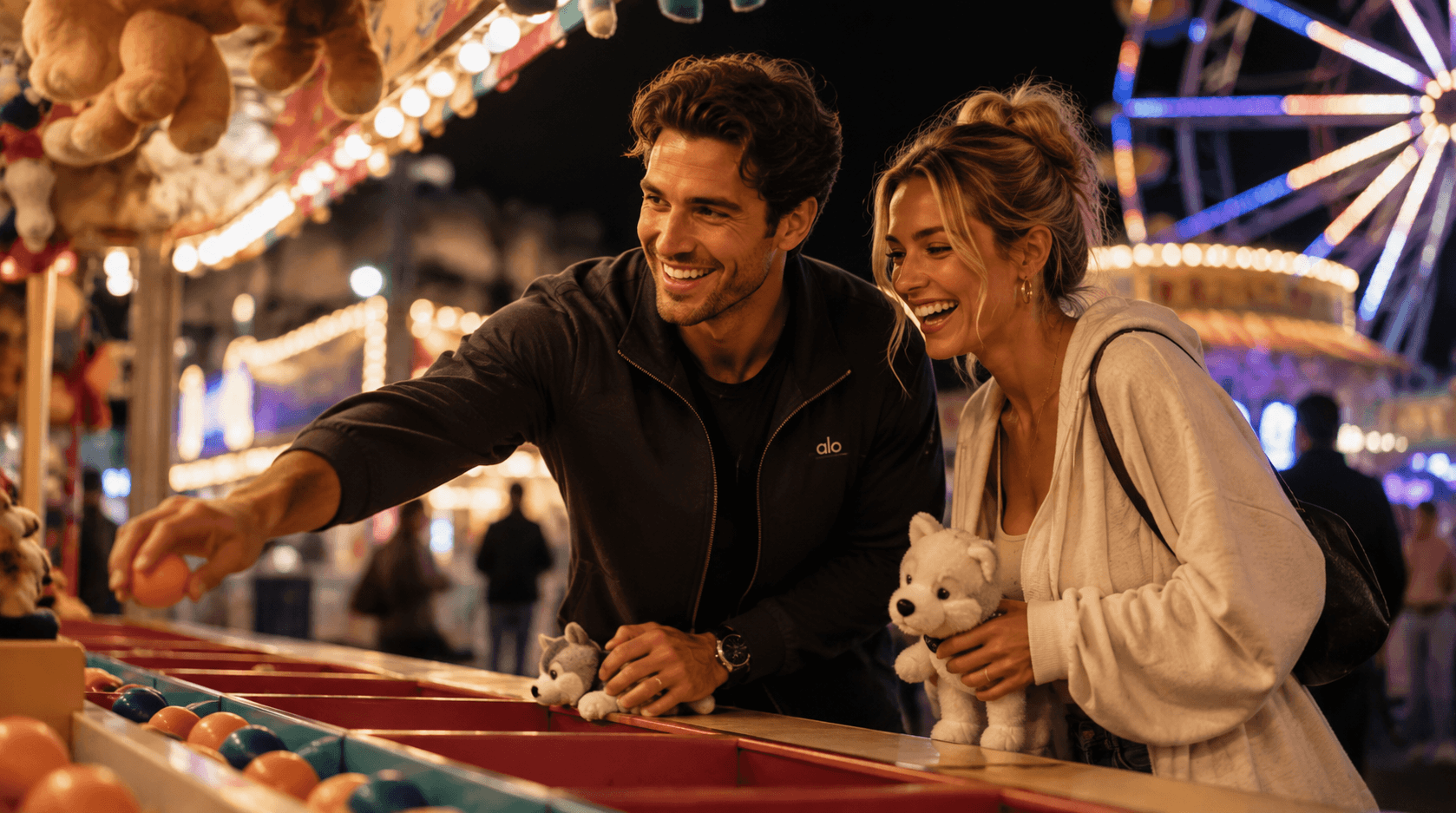 A couple laughing together at a carnival game booth on a night out